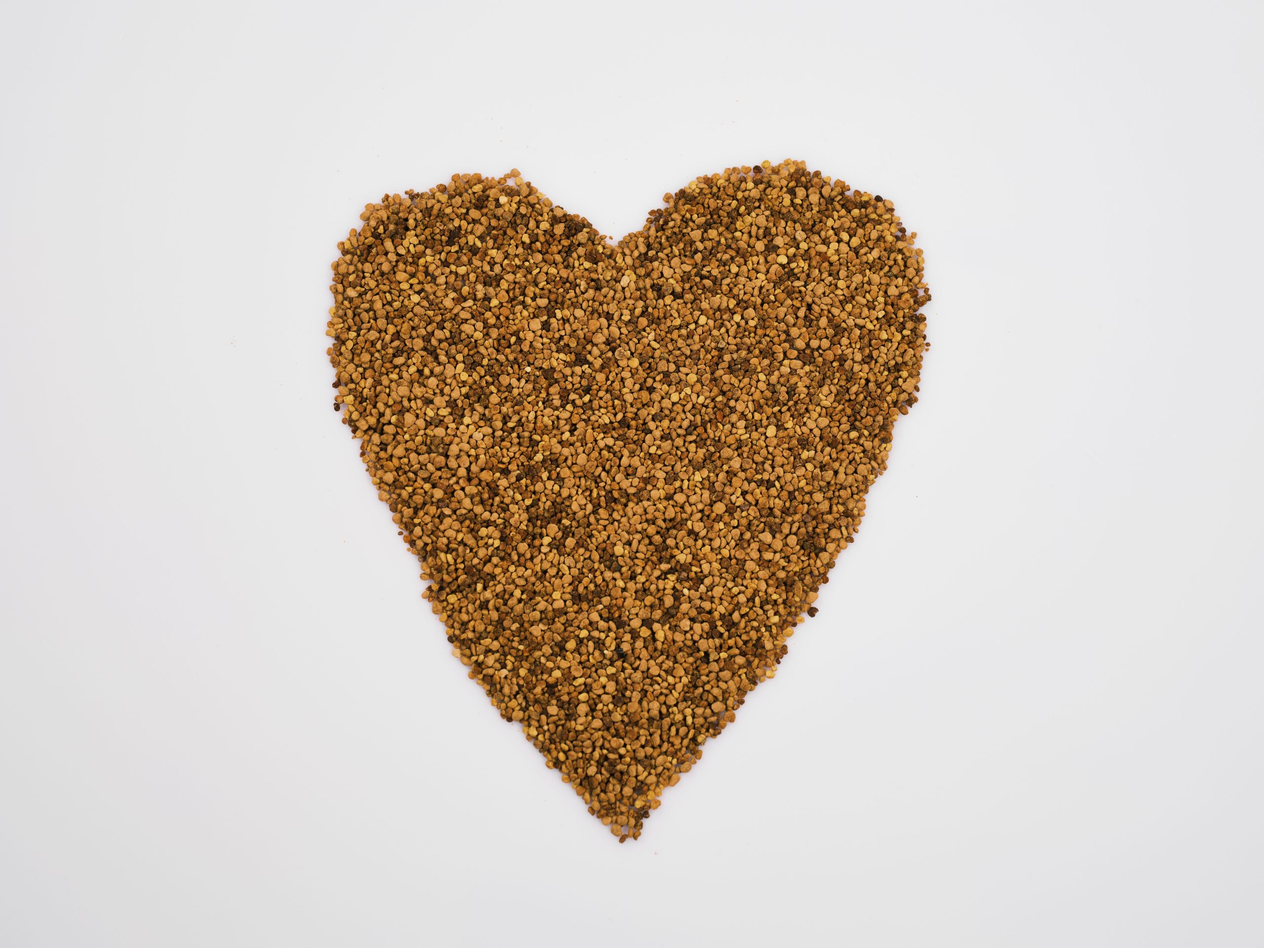 Heart-shaped arrangement of nutritious grains symbolizing health and love.