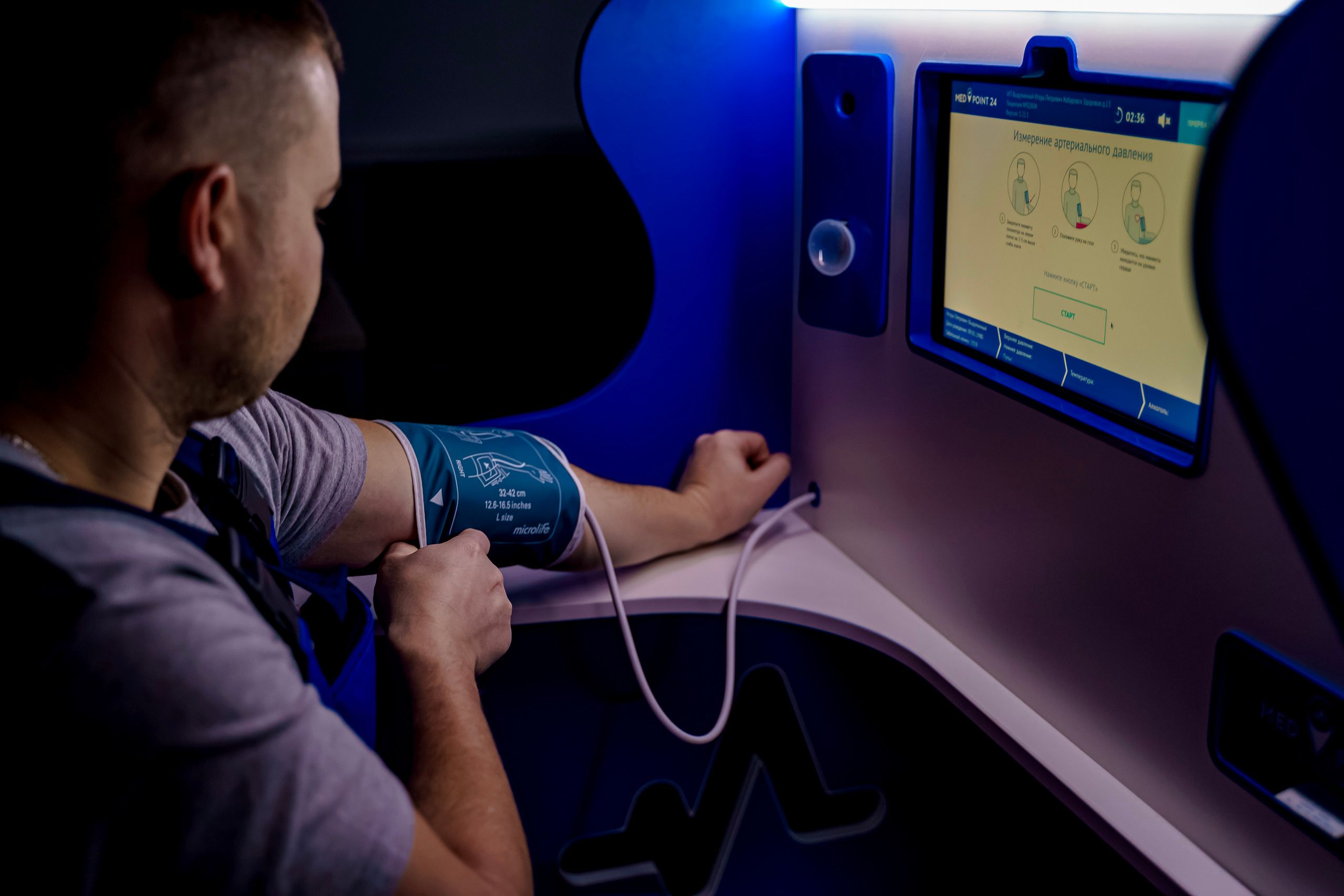 Adult using a modern digital blood pressure monitor indoors.